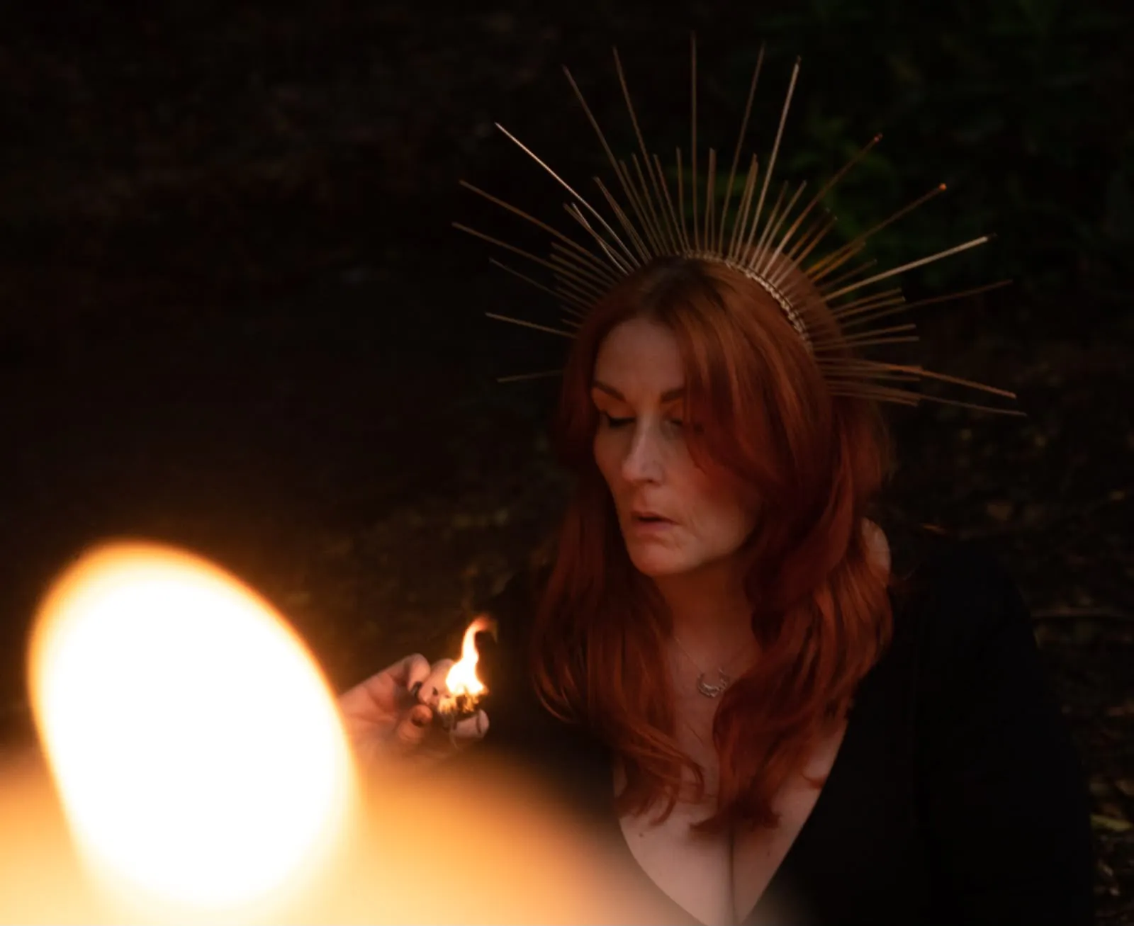 Cate McMurray by candlelight wearing a golden crown