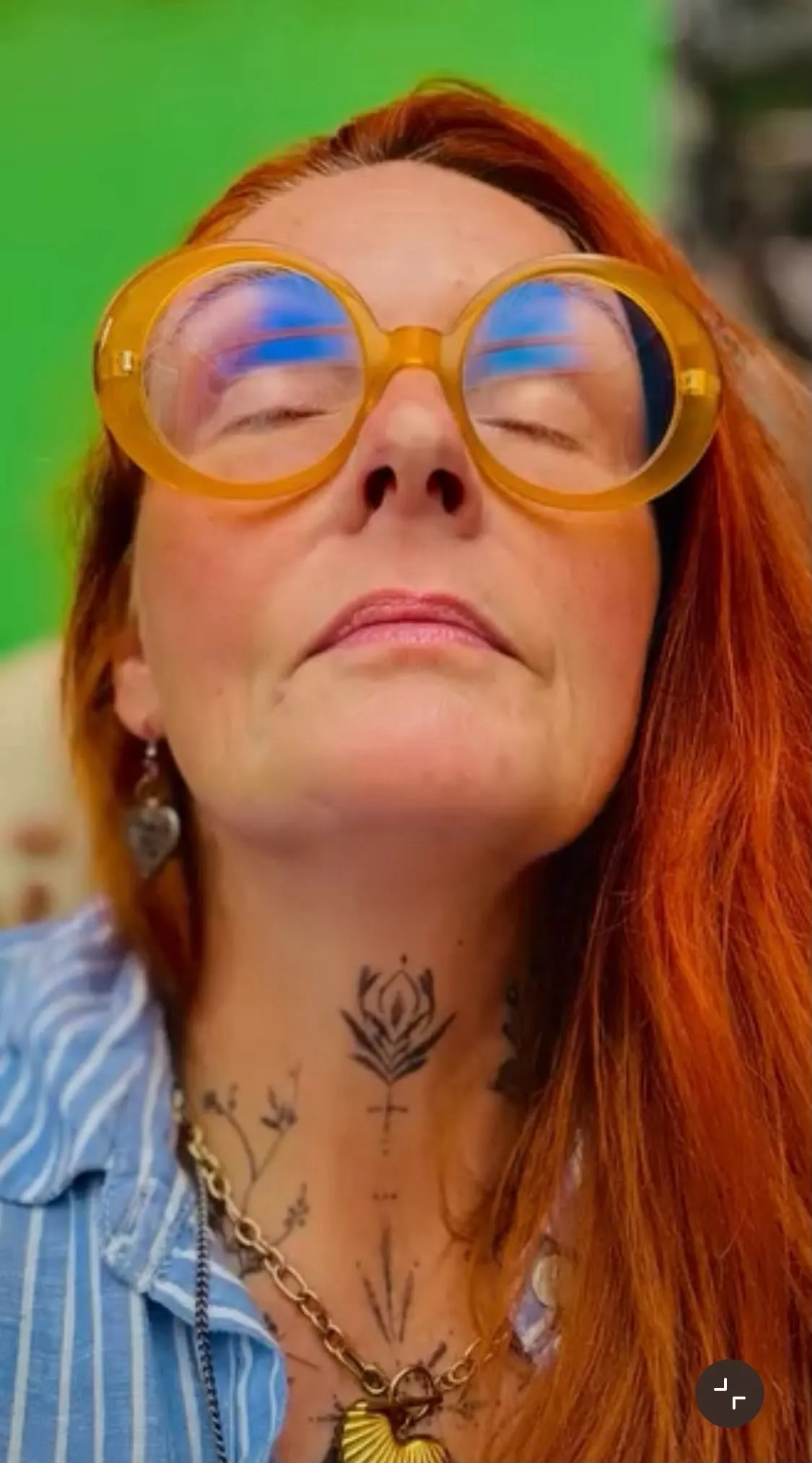 Cate McMurray with eyes closed in meditation wearing orange glasses